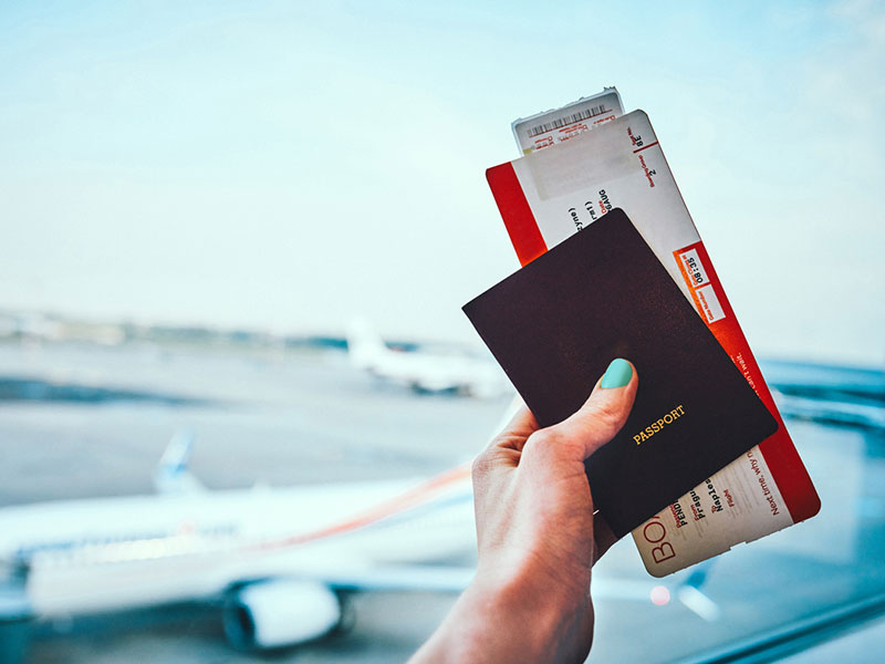 woman at an airport - How To Save Money On Airline Tickets