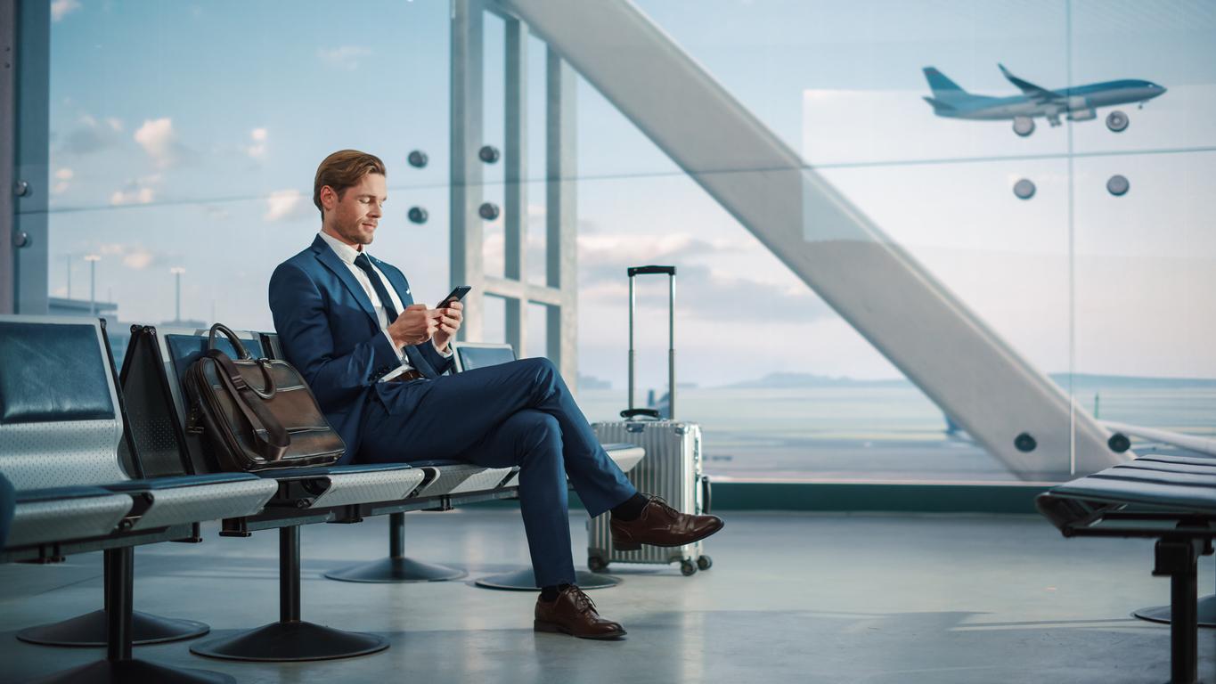 man at an airport - How To Save Money On Business Travel