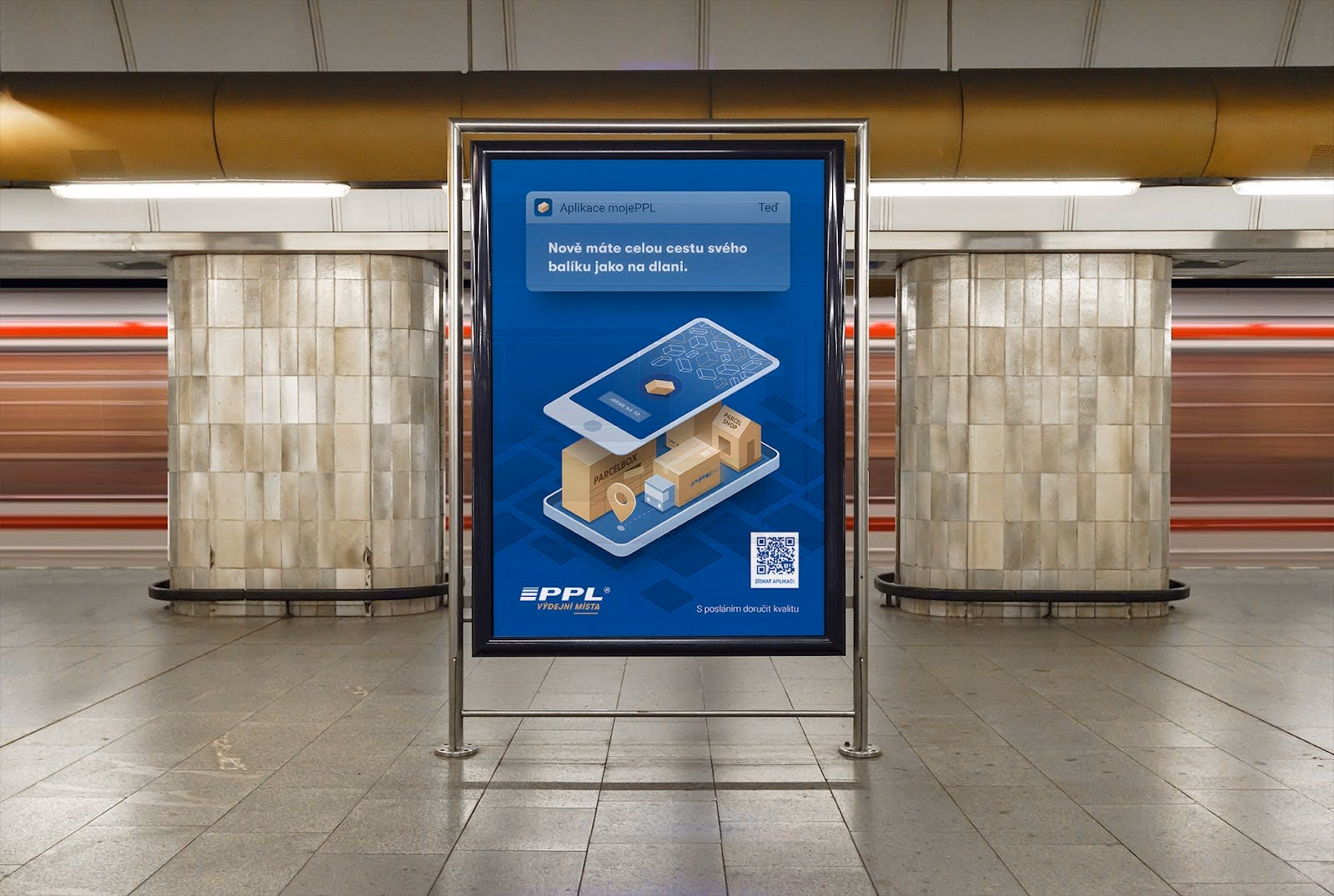 Advertisement in a subway station showing a smartphone with cardboard boxes and a location pin on its screen, promoting the PPL parcel delivery app.