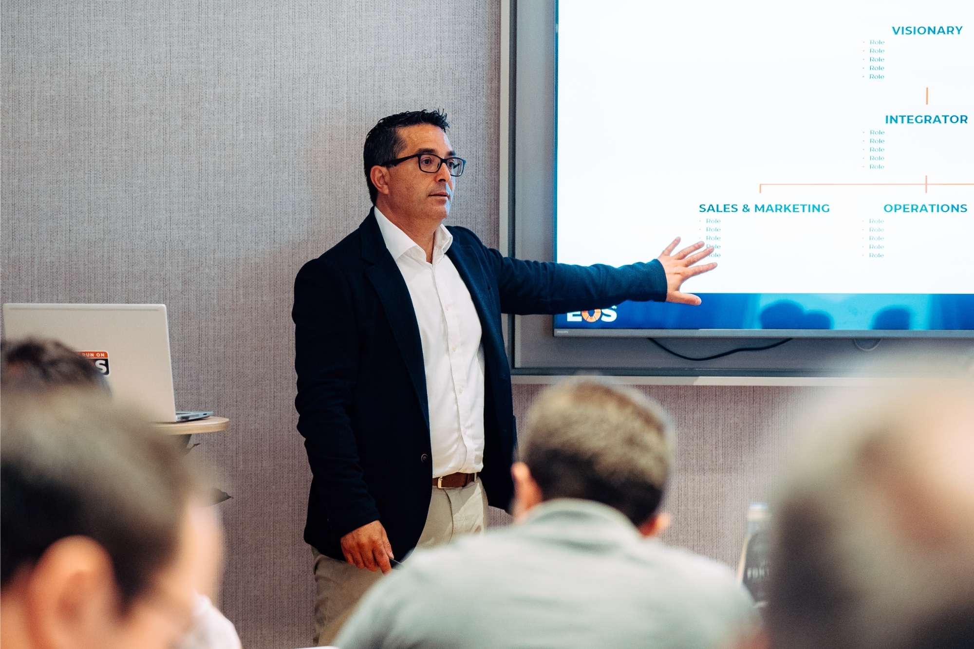 Presenter explaining the EOS Model® during a business management masterclass