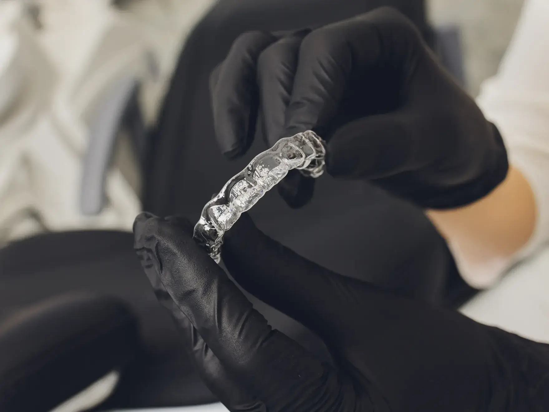 A close up of a person wearing black gloves.