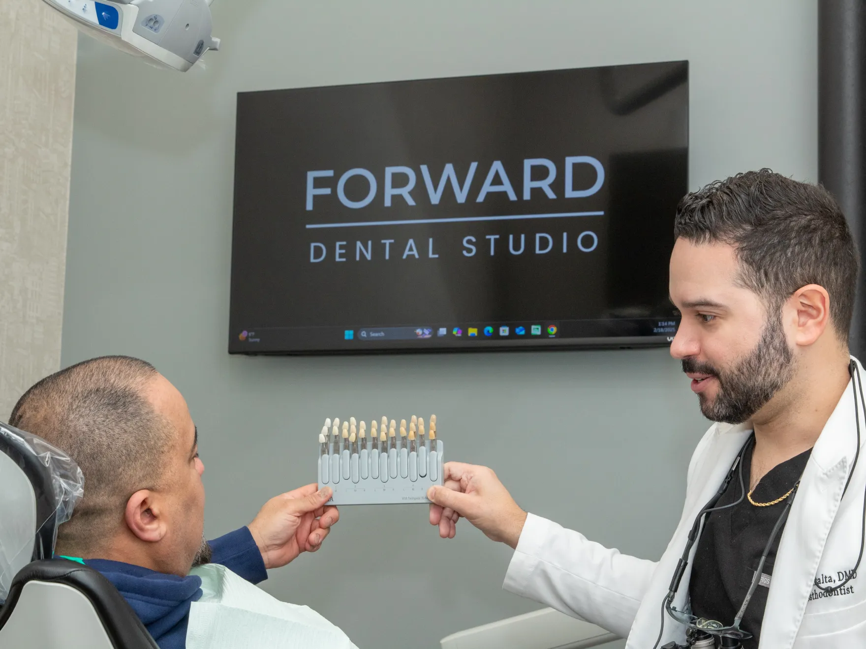 Dr. Peralta showing veneers to patient