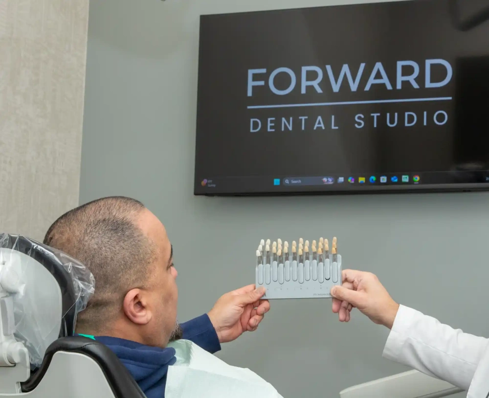 A patient viewing shades of veneers