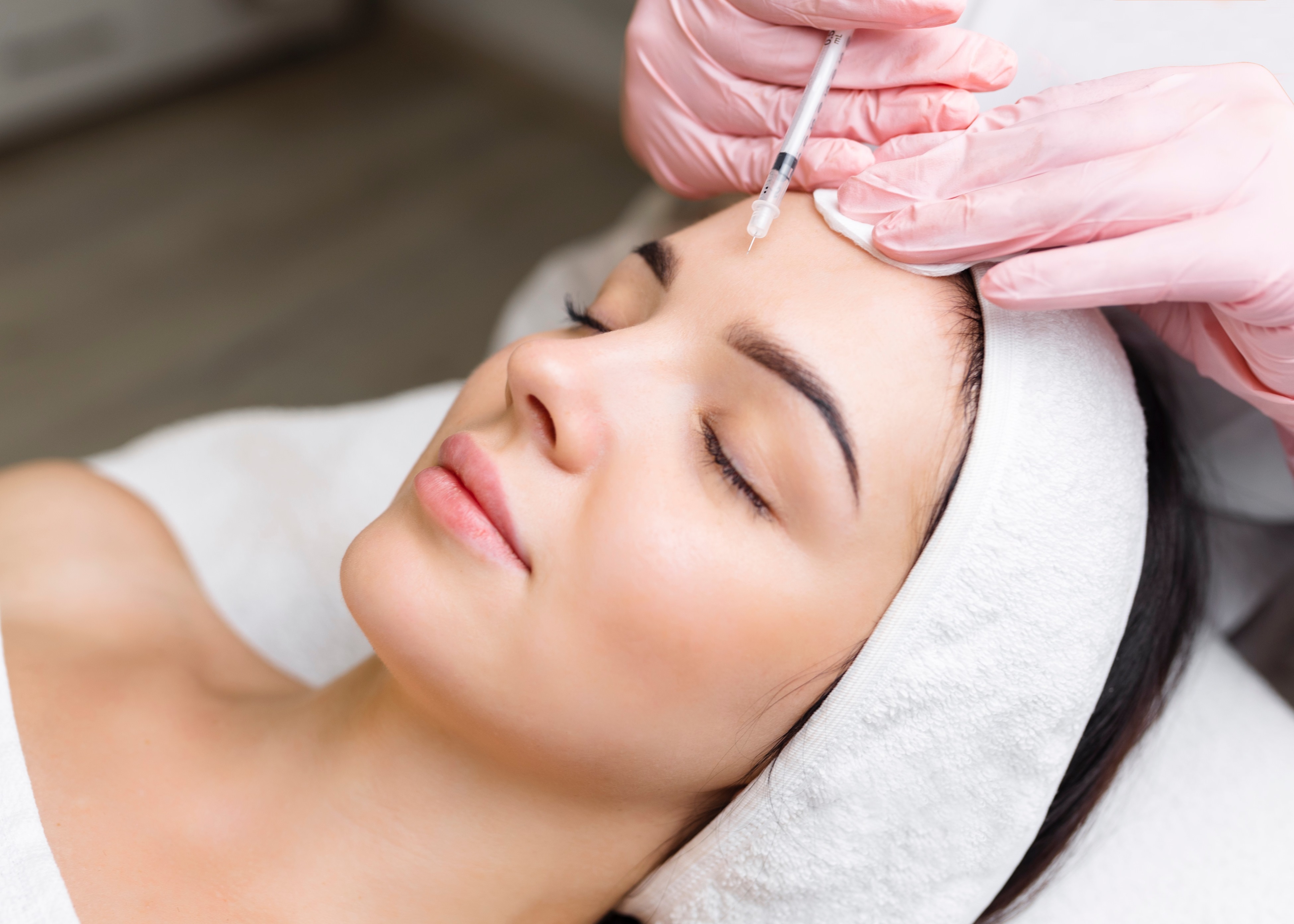 A woman getting a botilage treatment from a doctor.