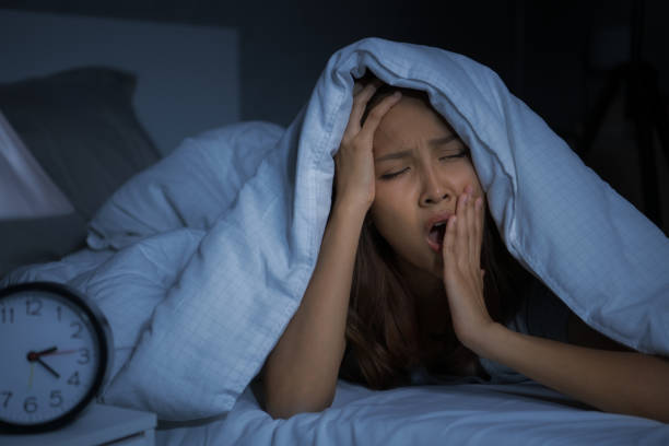 Depressed young woman lying in bed cannot sleep from insomnia Depressed young woman lying in bed cannot sleep from insomnia lost sleep because of jaw pain night time stock pictures, royalty-free photos & images