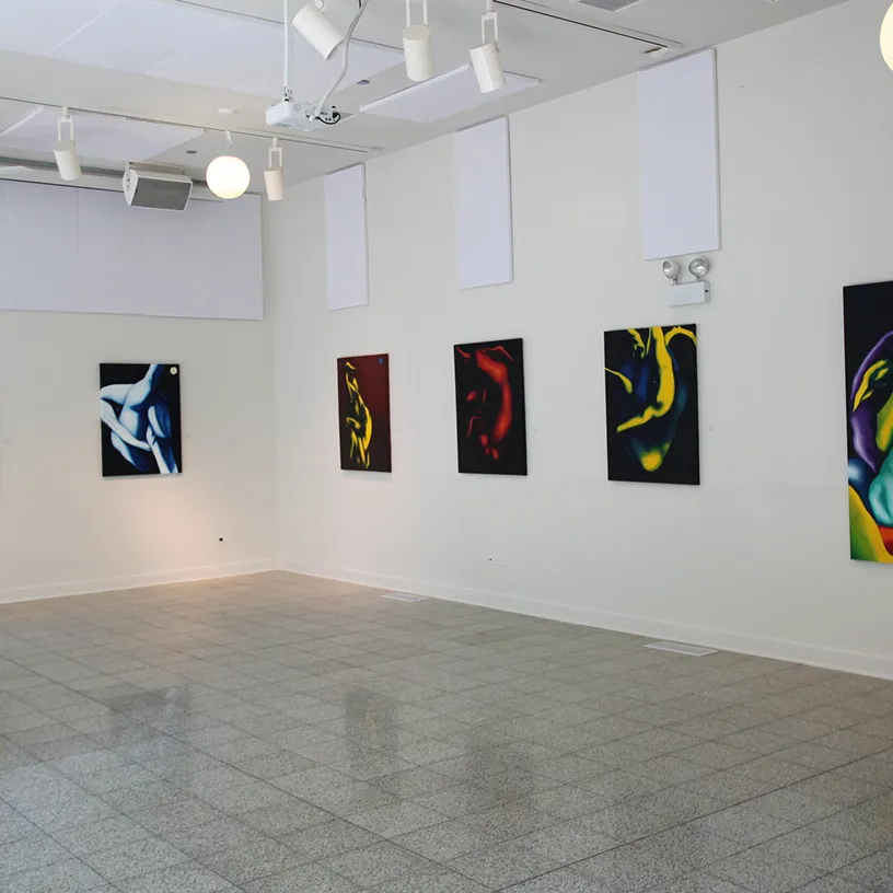 Gallery wall with five colorful abstract paintings of human figures.