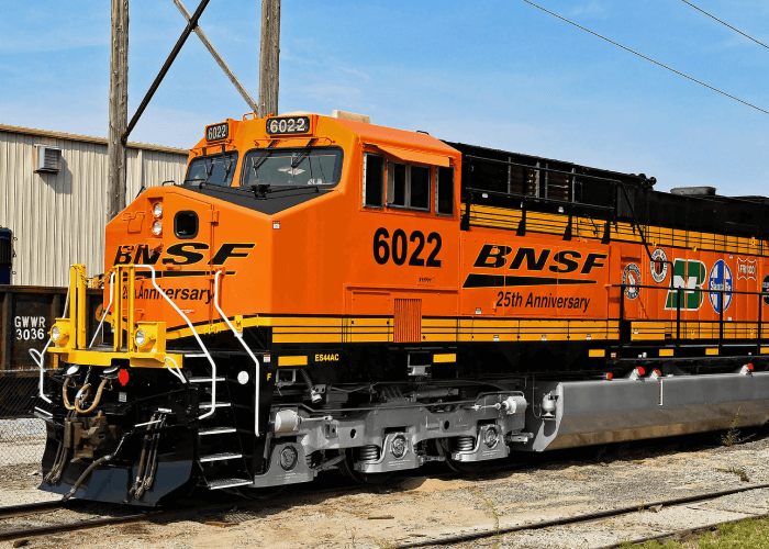 An Orange Train that says BNSF 25th Anniversary