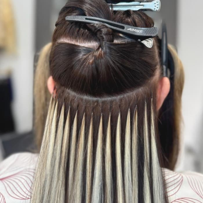 Strand-by-strand Ice Fusion Hair Extensions applied with invisible bonds in Houston.