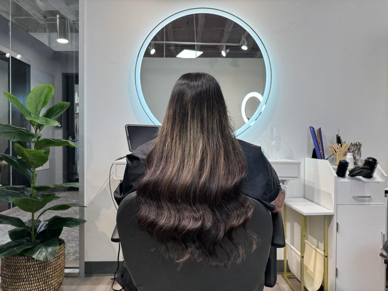 22 inch Ice Fusion Hair Extensions in Houston – 1B natural black color with soft light highlights by Bloom Studio Hair Extensions for a dimensional, glossy look.