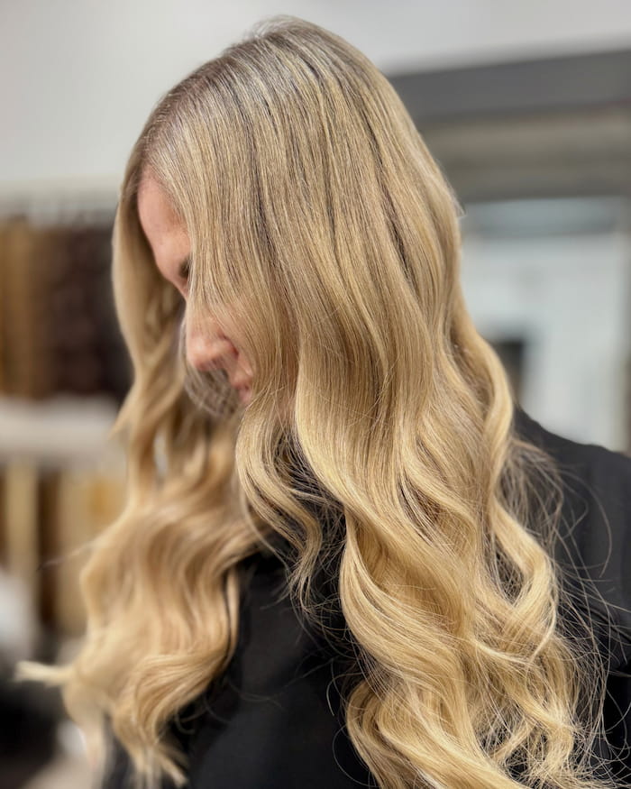 Blonde Ice Fusion hair extensions with natural waves and European Remy hair at Bloom Studio Hair Extensions in Houston