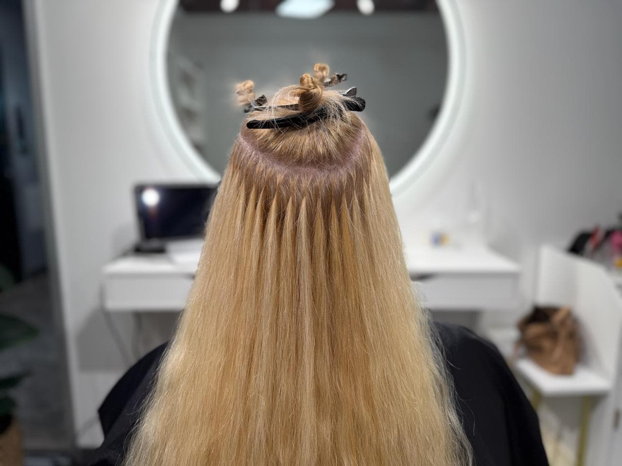 Ice Fusion Hair Extensions reinstall process in Houston — clean sectioning and micro-bonds applied with cold glue/gel at Bloom Studio Hair Extensions.