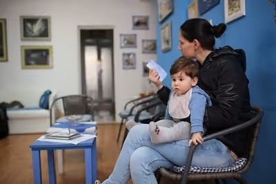 Woman holding baby in doctors office