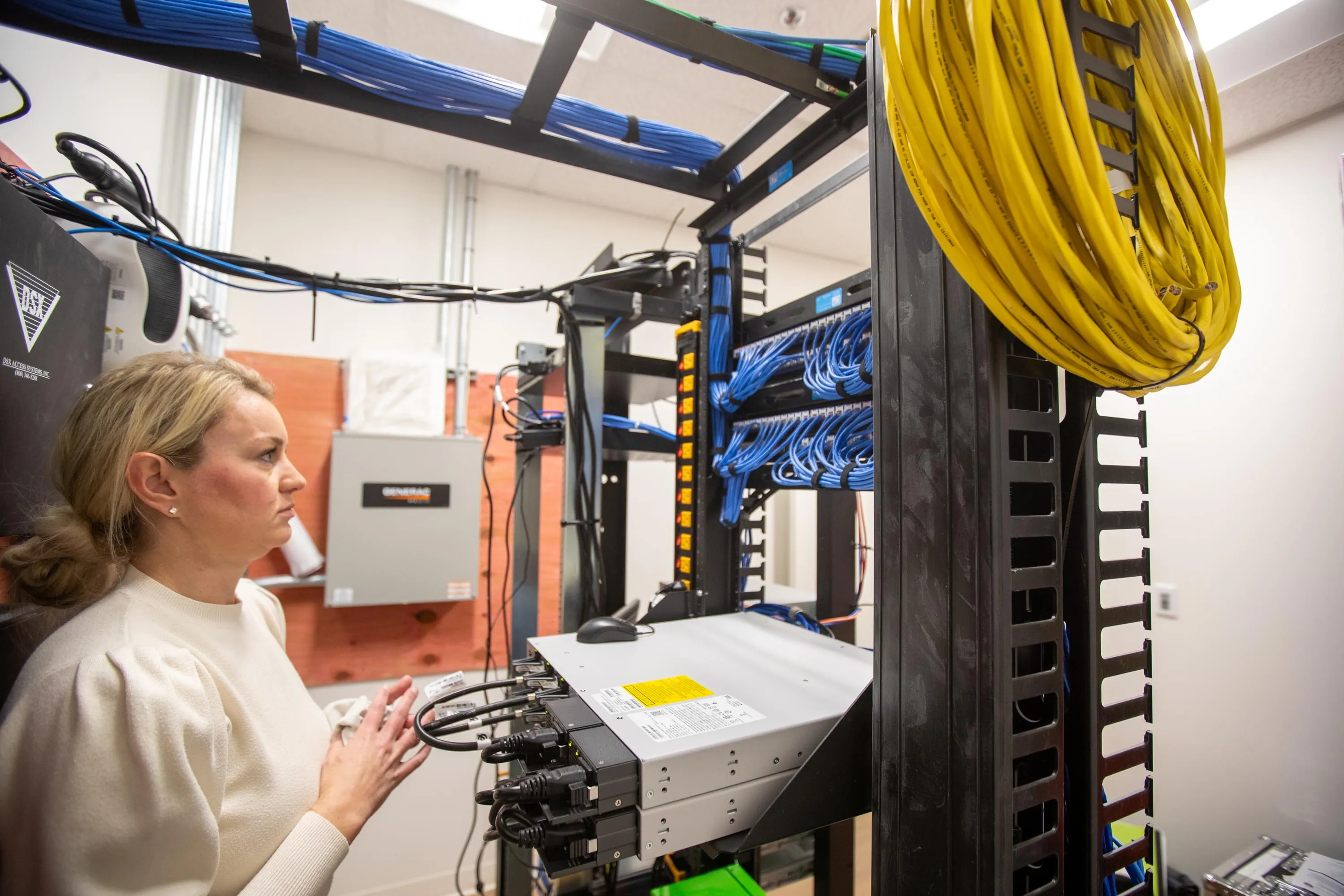 Avant Technologies technician inspecting a network rack in Kansas City