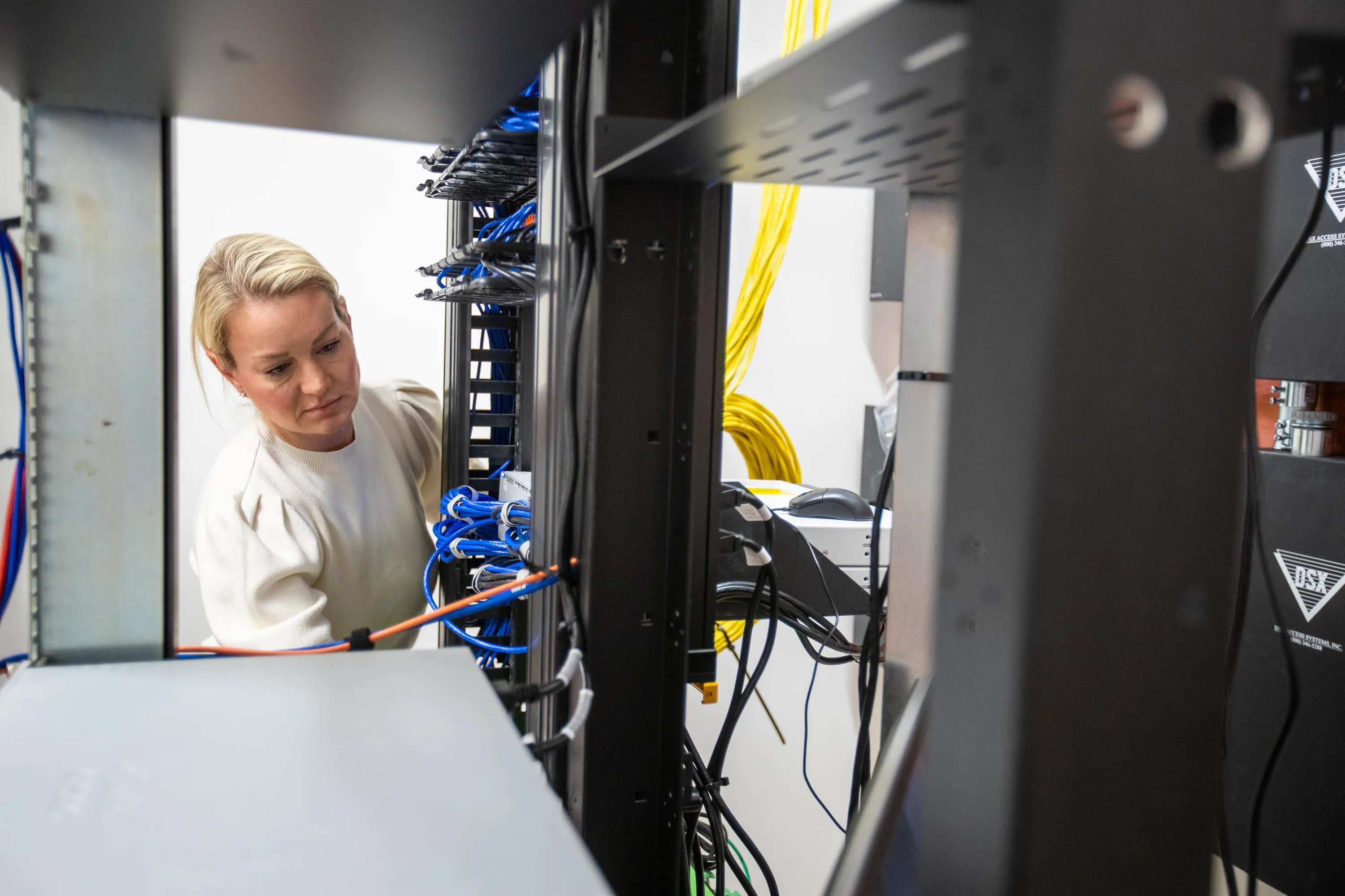 Avant technician working behind a network rack