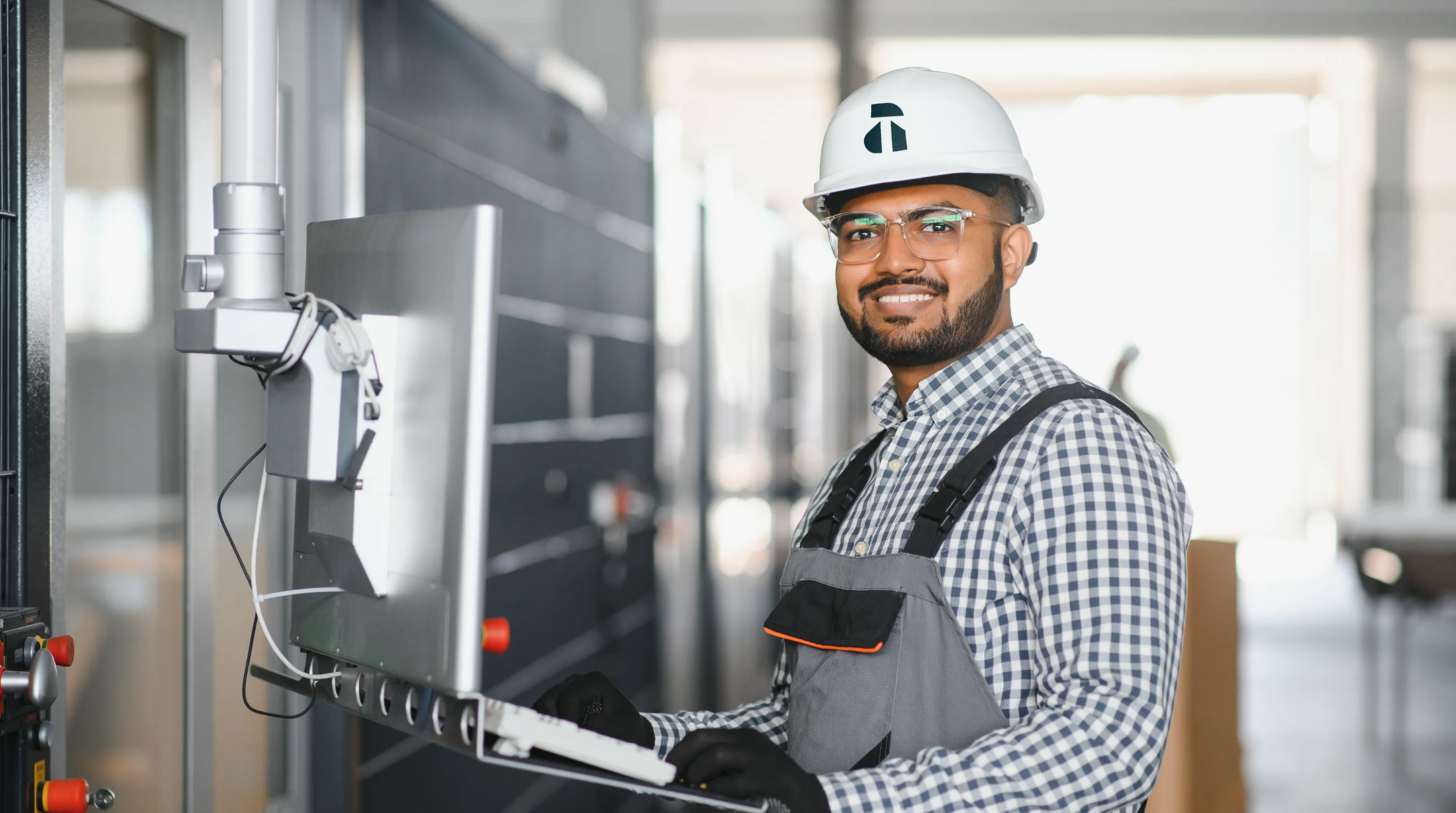Avant Technologies technician wearing a branded hard hat on a job site
