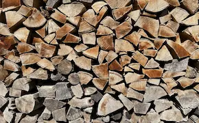 stack of chopped firewood logs ready for campfire at Unique Escapes NY