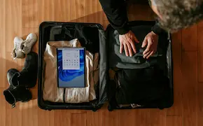 traveler checking in at reception desk with suitcase at Unique Escapes NY