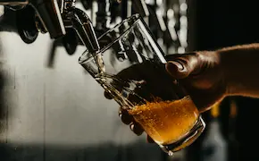 close-up of a beer being poured into a glass at Unique Escapes NY
