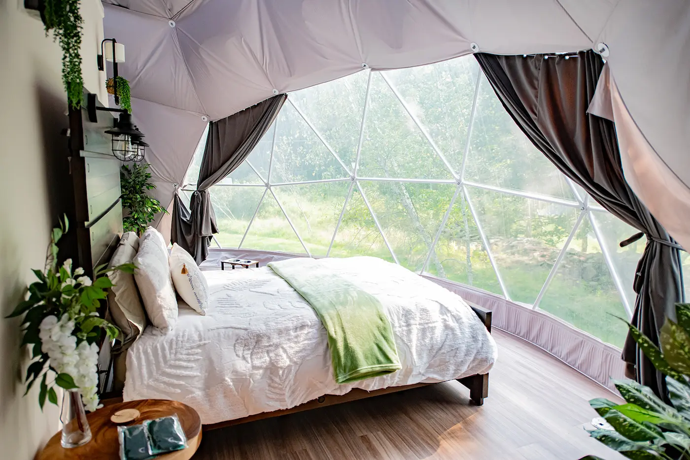 elegant Nature Lovers dome bedroom with open curtains and forest view at Unique Escapes NY