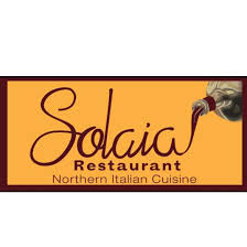 The elegant Solaia Restaurant logo, featuring the name in script font and a depiction of pouring wine, representing the upscale Northern Italian restaurant and its refined atmosphere and curated dishes.