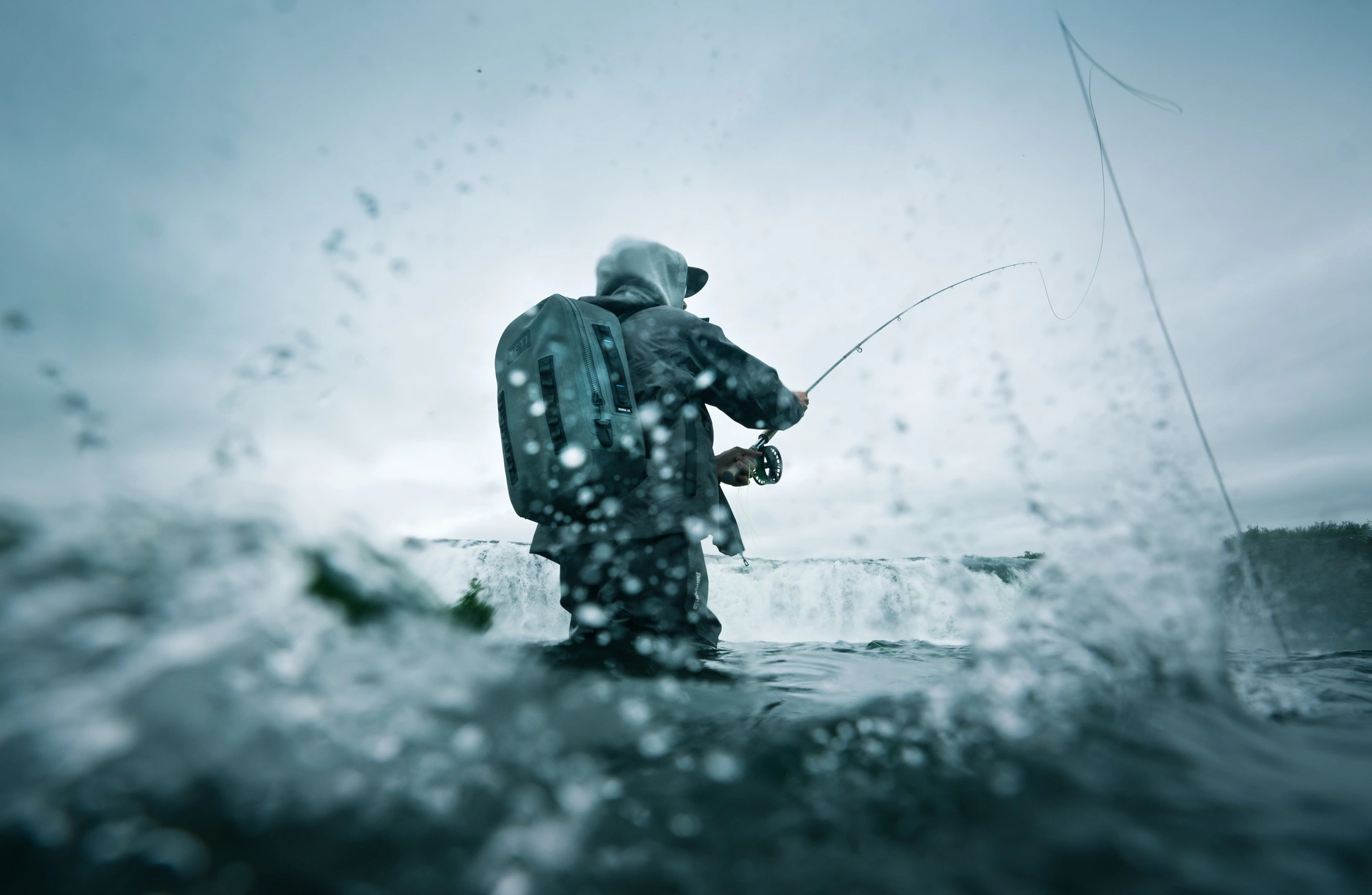 Close-up of black Leupold BX-5 Santiam 15x56 binoculars mounted on a tripod at sunrise in a desert landscape.