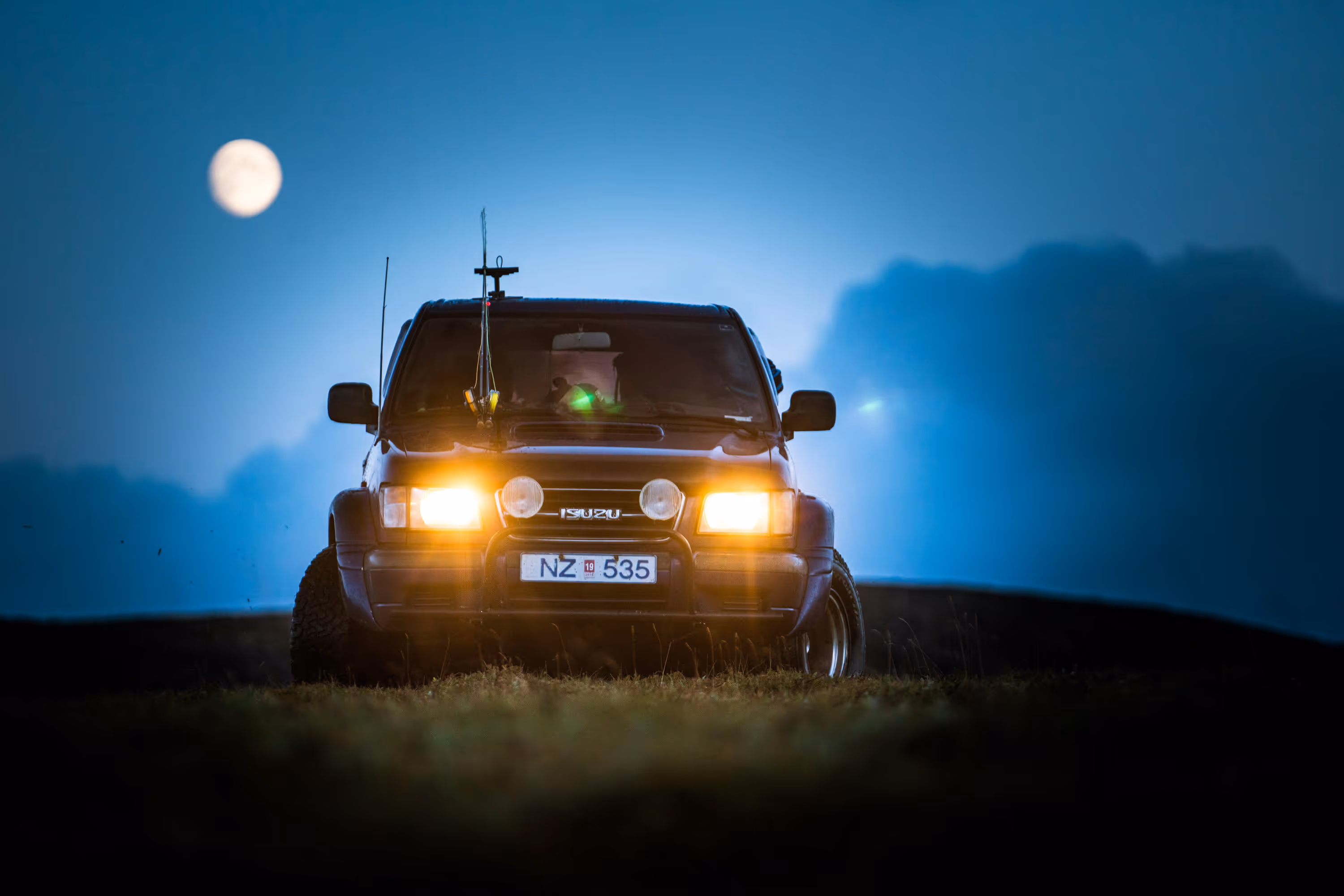 Close-up of a RED digital cinema professional camera with the RED logo and red button visible.