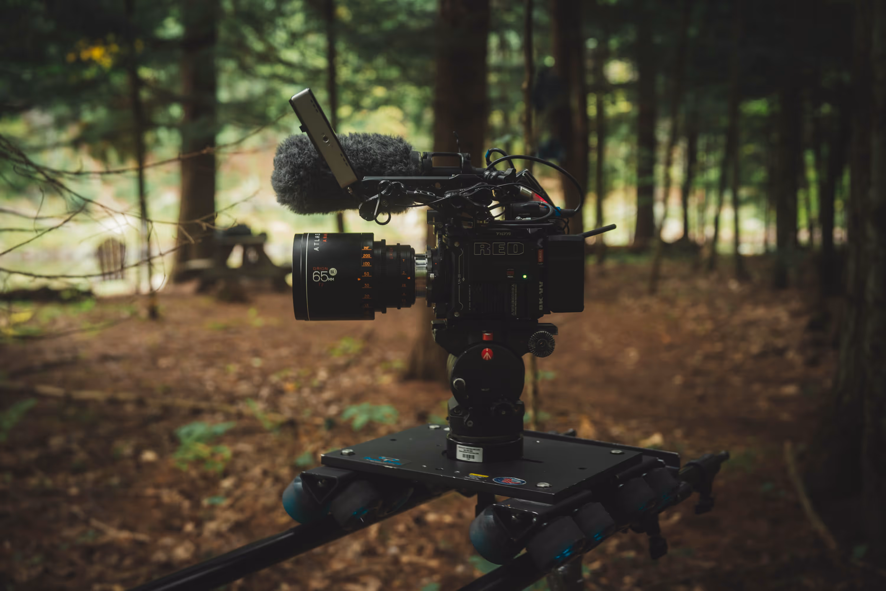 Close-up of black Leupold BX-5 Santiam 15x56 binoculars mounted on a tripod at sunrise in a desert landscape.