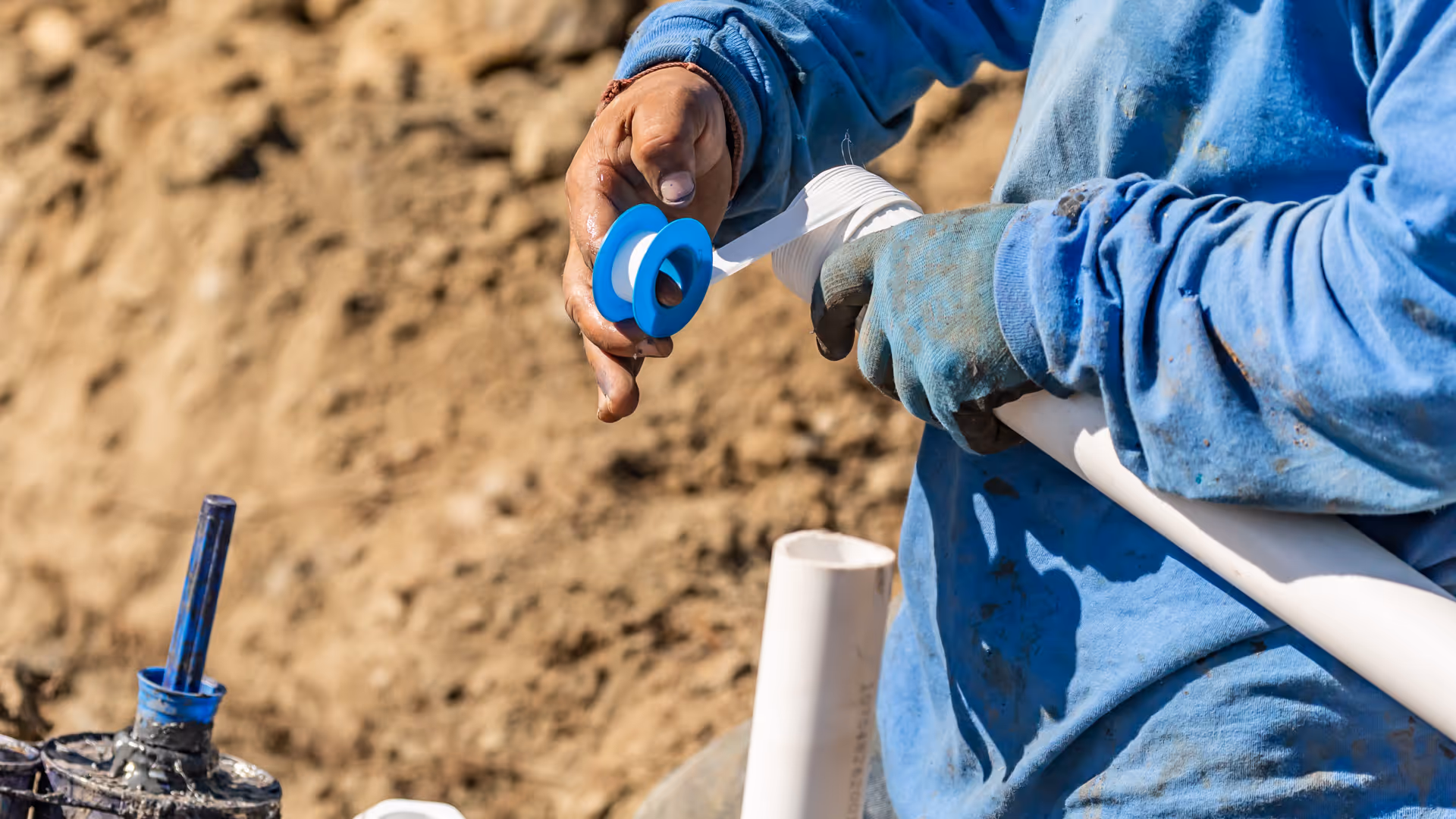 A plumber installing PVC pipes