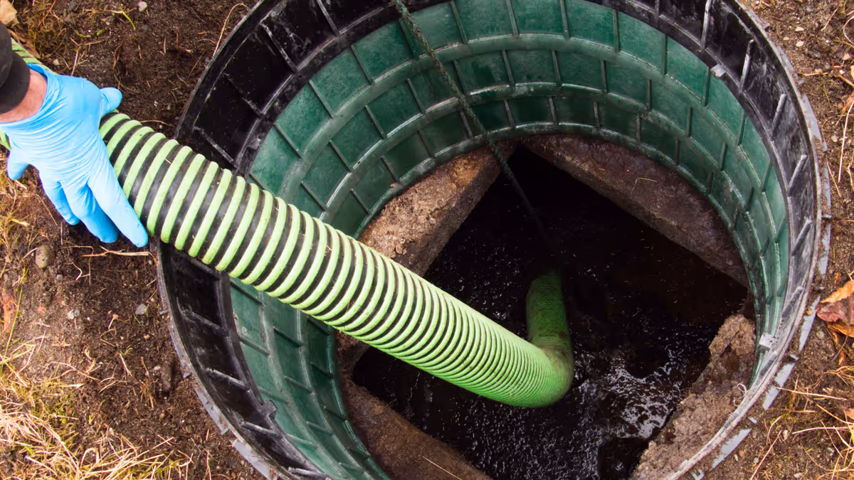 Top view of an open septic tank during pumping