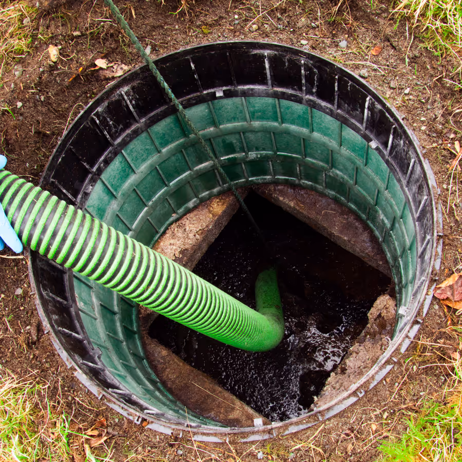Top view of an open septic tank during pumping