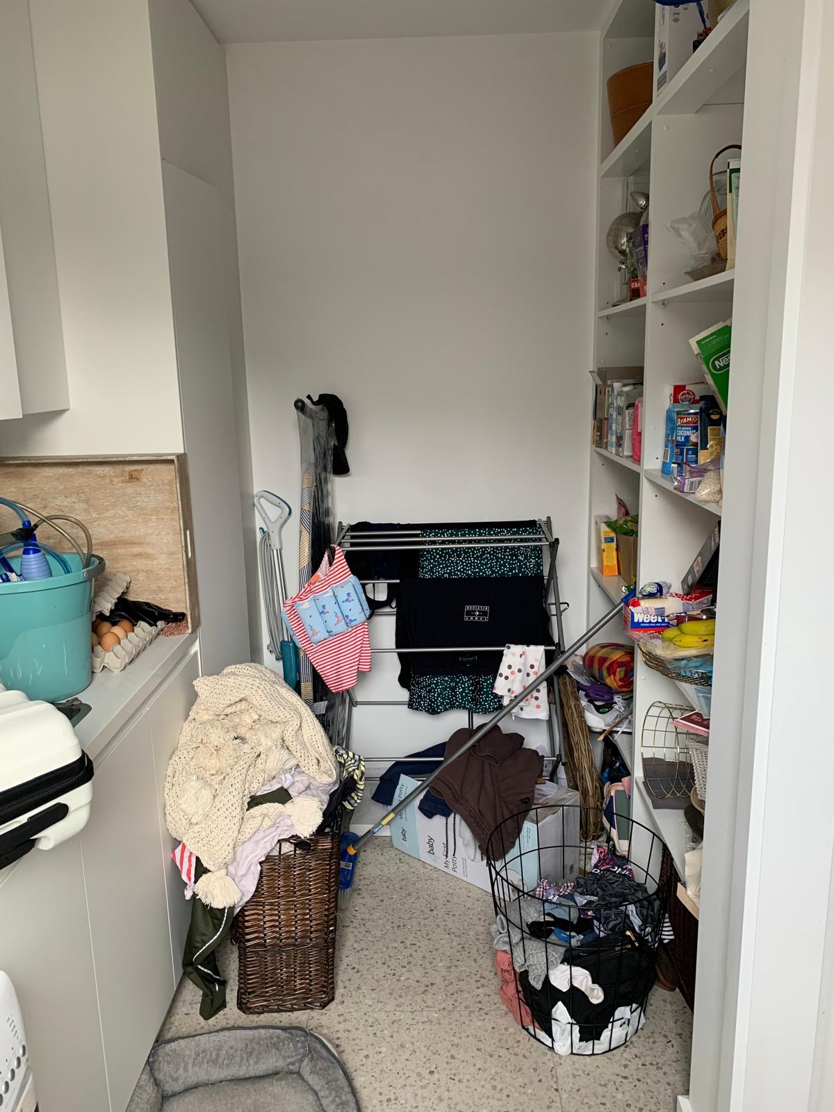 Pantry overflowing with groceries and household items, no clear system, hard to find essentials.