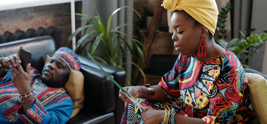 African man and lady relaxing and using Nuclyex APP on their phone