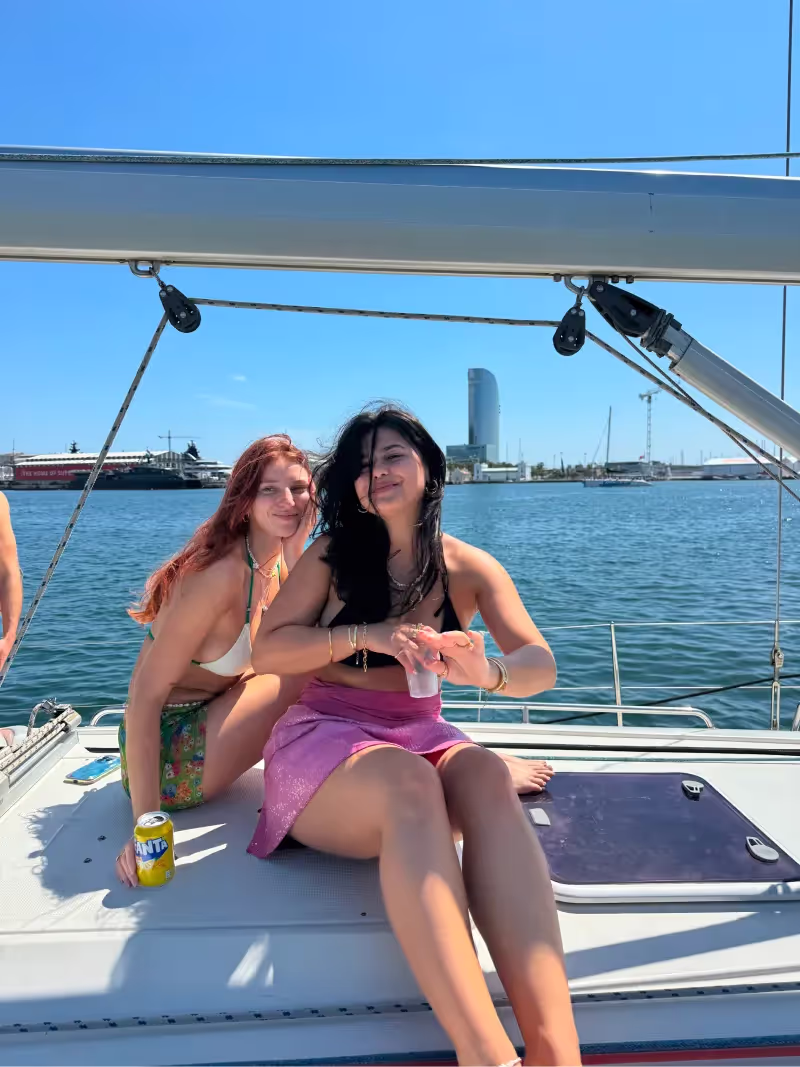 2 girls on a sailboat in barcelona for a birthday celebration