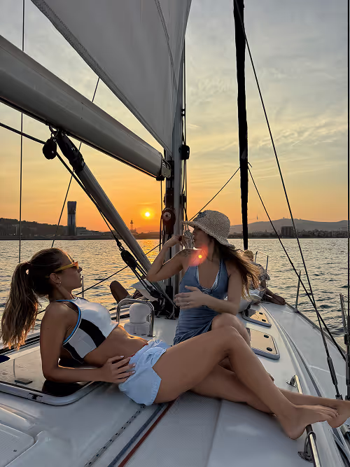 2 friends talking while sailing at sunset in barcelona