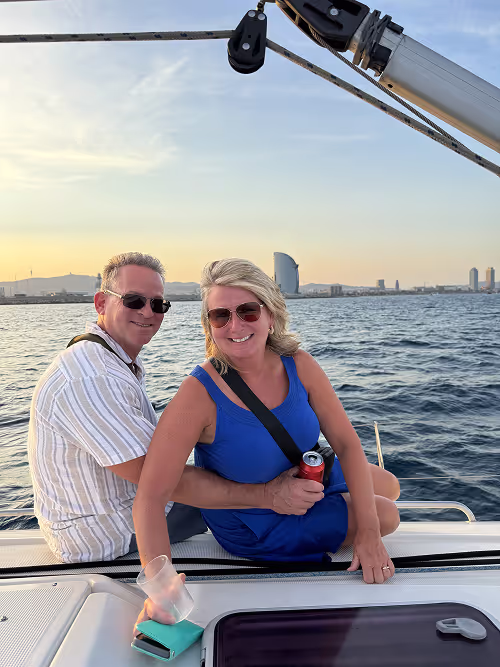 Couple enjoying a sunset boat cruise in Barcelona