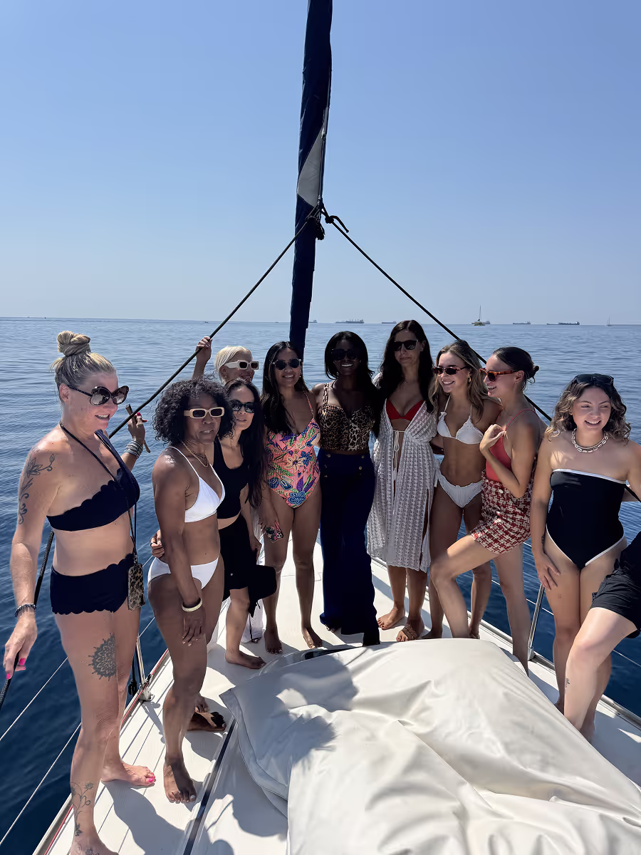 a group of girls enjoying a sailing tour in Barcelona with paddlesurf