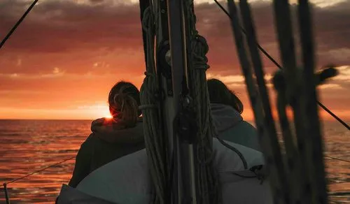 Sunrise reflecting on calm sea surface during a sailing tour in Barcelona