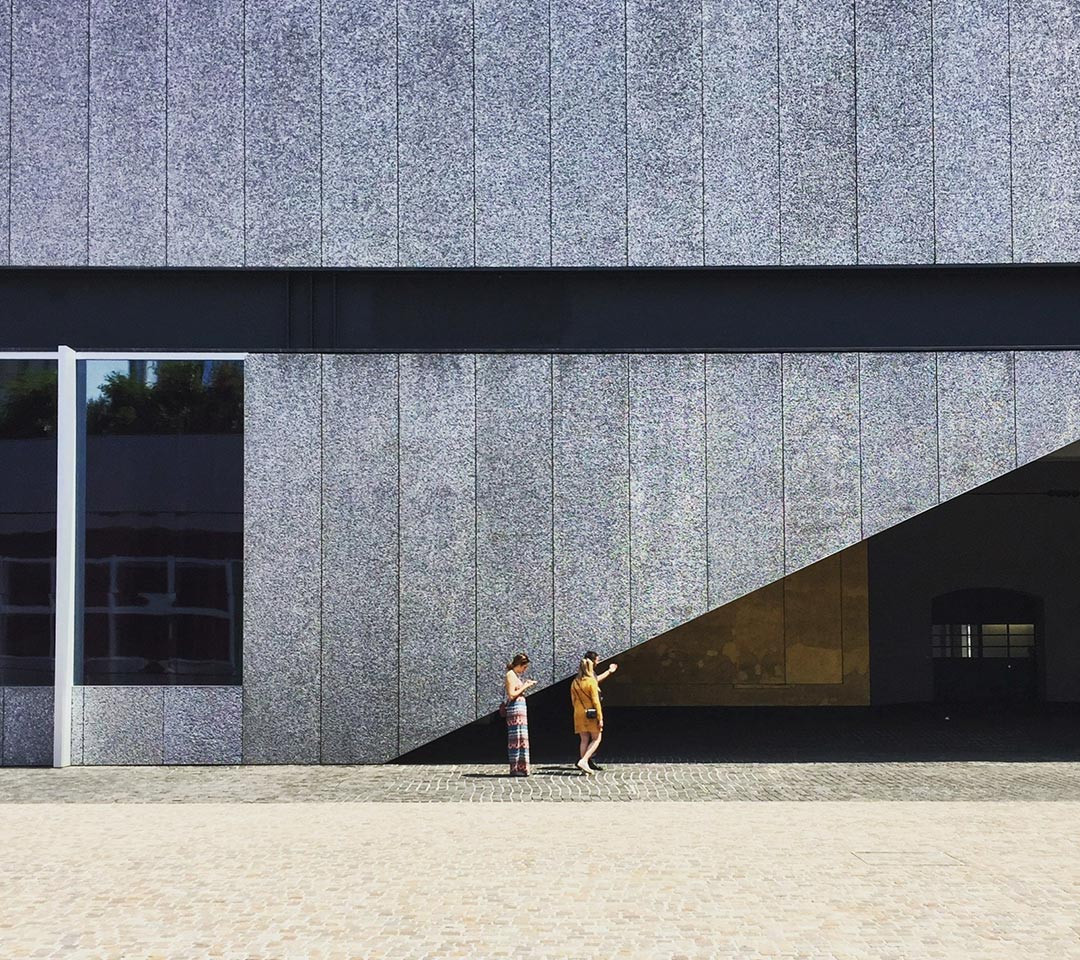 2 person in front of a wall