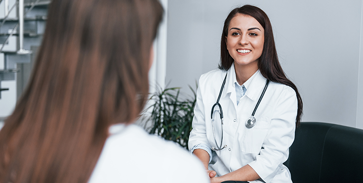 Woman doctor talking to patient
