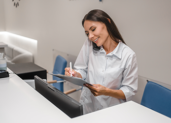 Woman working front desk at healthcare practice