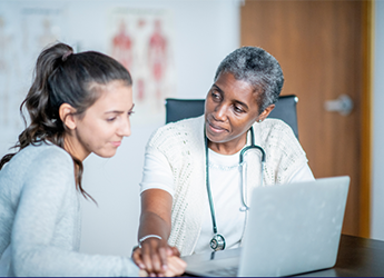 Two women looking at computer