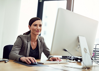 Woman working on medical claims with computer
