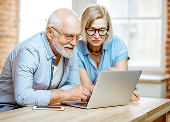 Man and woman looking at computer