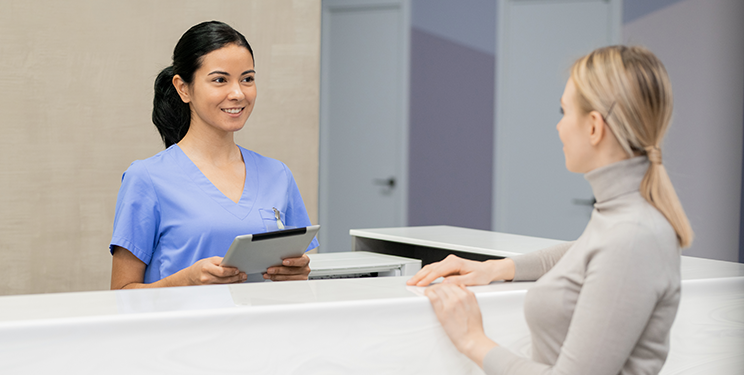 Woman checking in at doctors office
