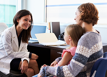 pediatrician meeting with mother and child in hospital