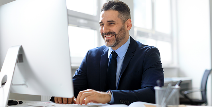 Man processes claims on computer