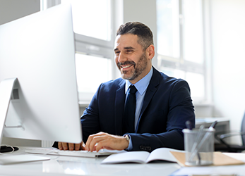 Man processes claims on computer