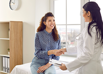 Happy patient shakes healthcare provider's hand