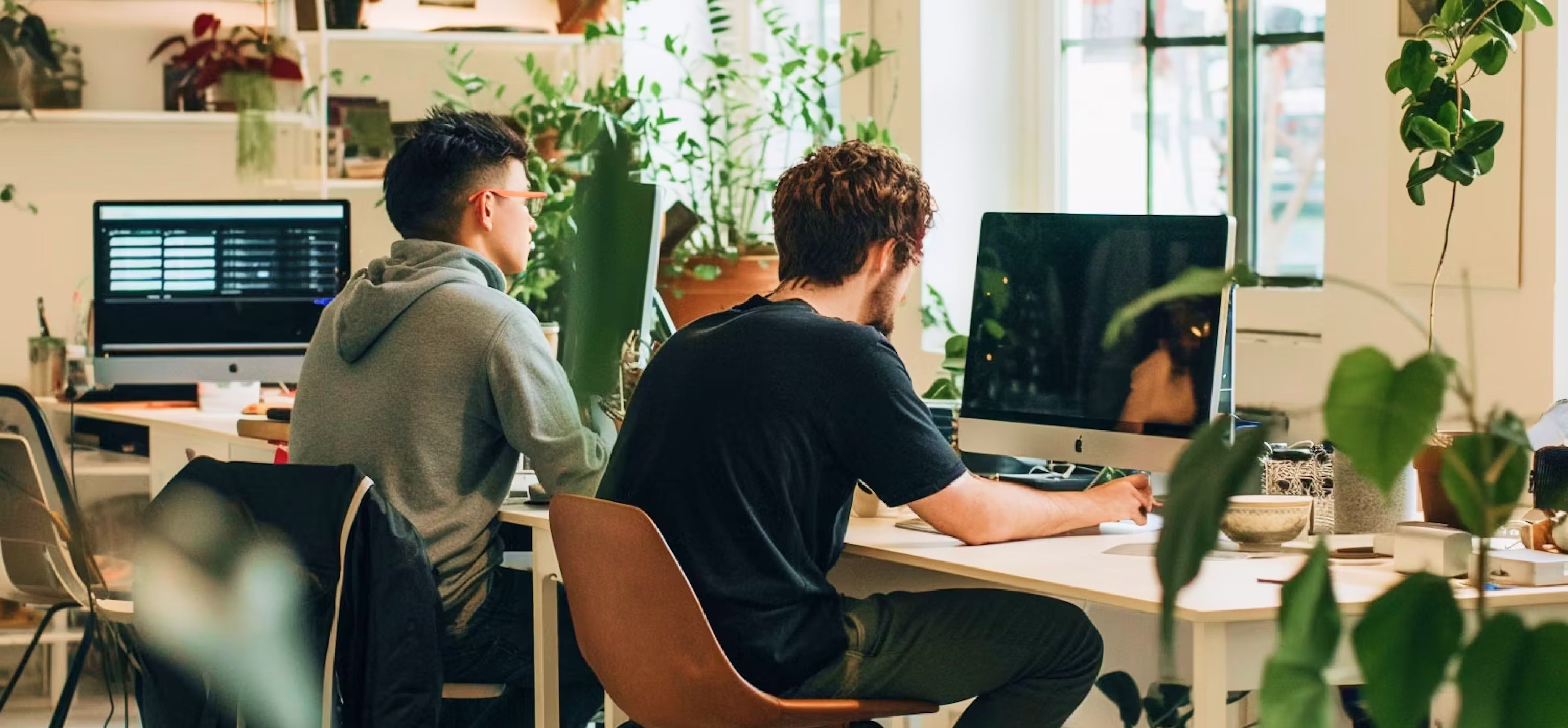 Modern office workspace with people working on computers.