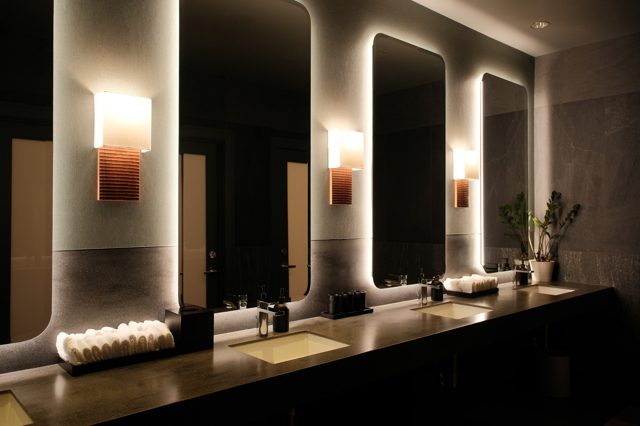 Well-lit corridor with wooden walls and a sign indicating the lounge and bar area on the left.